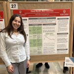 L&S Honors student Adina Kurzban stands in front of her research poster at Research in the Rotunda.