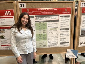 L&S Honors student Adina Kurzban stands in front of her research poster at Research in the Rotunda.