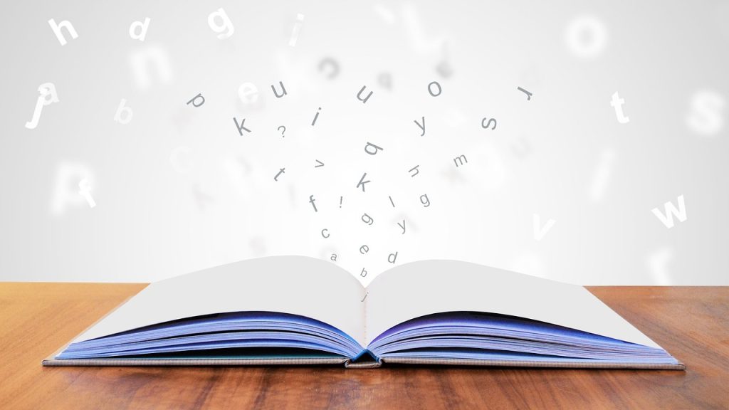 Open book with letters floating above it