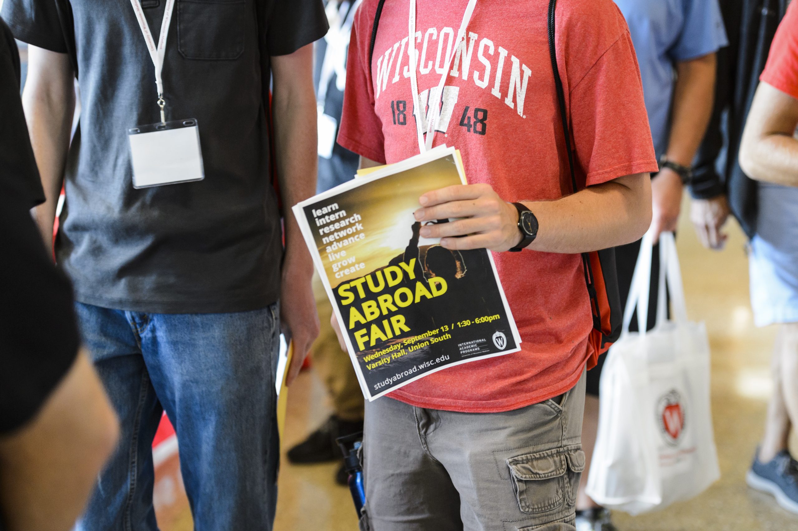 A student holds a flyer for the study abroad fair. 